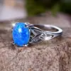 Deseo transfronterizo AliExpress moda viajero Palladium Blanco K forma de huevo borde de ópalo azul anillo cruzado suministro de fábrica al por mayor