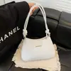 Bolsa vintage de axila com textura nicho para mulheres, nova tendência 2026 moda versátil simples de ombro transversal sela