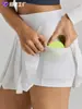 Nueva falda deportiva anti-exposición de alta venta para mujer para canchas de tenis y golf, con shorts de seguridad incorporados, mismo estilo que la marca