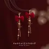 Pendientes de Perlas con Lazo Rojo para Otoño e Invierno Pendientes de Alta Gama para Mujer 2025 Nuevo Estilo Chino Pendientes Rojos