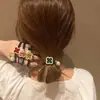 Corea del Sur Dongdaemun 1990, temperamento anillo para el cabello trébol de cuatro hojas diamante checo, cuerda para el cabello cola de caballo moño accesorios para el cabello