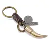 Llavero vintage minimalista de aleación con diente de animal, colgante tejido de cuero, accesorio para coche y bolso, adorno personalizado estilo bronce antiguo