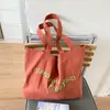 Bolso de lona con estampado de letras para mujer, nuevo y moderno bolso tote de moda primavera-verano 2026, bolso de hombro de gran capacidad estilo universitario