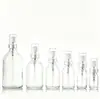 Botella Dispensadora Transparente Minimalista de 50 ml con Cierre a Presión y Cabezal de Bomba Spray a Prueba de Polvo, Botella de Vidrio Portátil para Viaje a Prueba de Luz para Agua de Rosas Pura