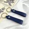 Llave de metal de cuero artificial PU doble cara de cuero -2 cuero pequeño llavero de regalo anillo de metal colgante simple 6g