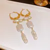 Pendientes de borla de flor de concha blanca transfronterizos europeos y americanos con perlas, pendientes de estilo de corte francés, pendientes ligeros y lujosos con un toque de alta gama