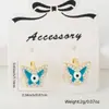 Aretes de Hebilla de Oreja Cobre Incrustado Circonita Ojos de Gota de Aceite Suministro de Comercio Exterior Joyería de Perforación de Moda Anillo de Hélice de Mariposa Perno de Oreja