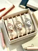 Pulsera de perlas superventas transfronteriza, reloj de cuarzo con números romanos para mujer, disponible en stock, tres colores para elegir