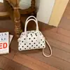 Bolso bowling casual minimalista de estilo coreano, de nicho, con lunares, modelo nuevo 2026, con un toque de alta gama para ir al trabajo, bolso de hombro y cruzado