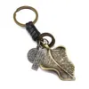 Bestseller transfronterizo llavero retro personalizado de pluma dorada con colgante tejido de cordón de cuero, regalo creativo unisex