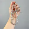 Correa de teléfono de lazo de perla de cristal al por mayor, cordón de teléfono anti-pérdida de alta gama para amigas, accesorio de regalo