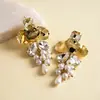 Pendientes de borla de flor de concha blanca transfronterizos europeos y americanos con perlas, pendientes de estilo de corte francés, pendientes ligeros y lujosos con un toque de alta gama
