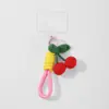 Explosiones transfronterizas moda coreana exquisita crochet a mano color cereza simulación cuerda de combinación llavero colgante para teléfono móvil