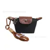 Super Mini Bolsita de Bolso Dragon Fragante 2024 Nuevo Estilo Francés Nylon Cuero Cabezal de Cambio Auriculares Lápiz Labial Llave Bolsita Pequeña Colgante en stock