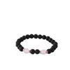 Accesorios de explosiones transfronterizas piedra volcánica negra mate de 8 mm piedra de ámbar fósil de viento pulseras de yoga para hombres y mujeres al por mayor