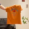Camiseta de manga corta con estampado de letras color naranja dopamina para mujer, nuevo estilo de verano 2026, holgada y estilizada, top de cuello redondo