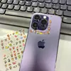 Nova capa de celular Bape com decorações fofas de desenho animado, apresentando mini macaco Bapebape e adesivos de margarida
