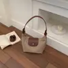 Moda casual de tendencia transfronteriza 2026 verano nuevo popular bolso de mano para axila de mujer, bolso tipo empanada, bolso de hombro y bandolera