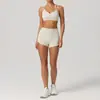 Conjunto de sujetador de yoga y shorts estilo europeo y americano color durazno nude para realzar los glúteos, pantalones de fitness de secado rápido de tres puntos, pantalones deportivos para correr
