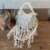 Bolso tejido para mujer, nuevo modelo de verano 2026, nicho y súper popular, bolso de hombro para el trabajo, bolso cruzado con borlas, bolso de playa de paja