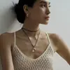 Nuevo Collar Minimalista de Gota de Agua Fría en Cuerda de Cuero Negro Metalizado para Mujer Diseño de Nicho Simple y Exquisito Cadena de Suéter de Alta Gama