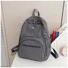 Mochila de nylon leve de cor sólida, simples e estilosa, adequada para alunos do ensino fundamental II e médio, versátil para viagens e uso ao ar livre