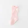 Calcetines nuevos para niños y niñas de color sólido a rayas de algodón antideslizantes con boca de burbuja y lazo para bebé al por mayor
