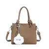 Bolso bandolera popular de diseño de nicho transfronterizo, bolso tipo cubo de piel sintética suave con patrón de lichi, bolso de mano moderno y sencillo para mujer