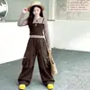 Conjunto de otoño para niñas 2026 nuevo modelo conjunto de dos piezas de imitación con top de retazos a rayas y pantalones cargo para niños venta al por mayor