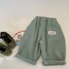 Liquidación, sin devoluciones ni cambios, 18 yuanesPantalones casuales de primavera y otoño Mai Bao para niños, lavado deslavado con logo personalizado en los bolsillos