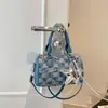 Bolsa de mano con textura de alta calidad al por mayor, bolsa tipo almohada, bolso para mujer, nuevo de otoño 2026, bolso de hombro de mezclilla a cuadros, bolso cruzado para el trabajo
