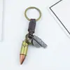 Llavero creativo para hombre y mujer, regalo pequeño, aleación, bala, tejido vintage de cuero, llavero con colgante de cuero