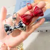 Hebilla de puerta K30 estilo metal de alta gama llavero de arco plateado accesorios colgantes para bolso de chica estudiante de teléfono móvil