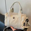 Bolsa de Lona Leve Estilo Casual para Mulheres 2025 Novo Estilo Coreano Nicho Bolsa de Mão para o Dia a Dia Bolsa de Ombro Único Transversal