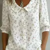 Nova Camisa Europeia e Americana Cruzada Amazon Primavera/Verão 2026 Solta Casual Vintage Botão Bordado Floral Manga Média