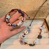 Pulsera trenzada con botón de estrella de mar azul claro y tablero de ajedrez 2025 Nuevo estilo festivo Joyería pequeña y fresca para la playa