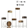 Frasco de almacenamiento sellado de vidrio de borosilicato de 47 mm de diámetro con tapa roscada de madera de acacia para dispensar polvo y gránulos