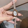 Reloj de pulsera romántico Dinimi para mujer, esfera ovalada con fritilaria y temperamento de diamantes de imitación, reloj de cuarzo sencillo para mujer.