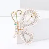 [Liquidación] Broche de flor de pavo real con diamantes de comercio exterior europeo y americano, pines de gatito bailando, accesorios para ropa de hombre y mujer