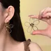 Brincos de Tarraxa Flor de Olho de Tigre Tecido de Linha Minimalista Estilo Coreano para Mulheres Design de Nicho Senso Retro Versátil para o Dia a Dia