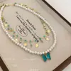 Mar Frío y Mariposa ~ Collar de Perlas Doble Capa Mariposa Azul para Mujer 2025 Nuevas Explosiones Cadena para Clavícula con Borla Superpuesta
