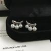 Aretes de aguja plateada estrella sonrisa circonita perla diseño nicho lujo ligero personalidad única joyería para la oreja mayoreo