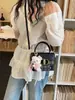 Bolso pequeño rosa a cuadros súper popular para mujer, nuevo bolso cruzado versátil de moda 2026, bolso cuadrado pequeño informal tipo caja estilo coreano