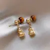 Brincos Olho de Tigre Estilo Melanoid Retro Senso de Design de Nicho Brincos Versáteis Luxo Leve Moda de Alta Qualidade Brincos de Tarraxa para Mulheres