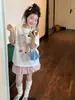 Conjunto de manga corta estilo coreano para niña 2026s verano camiseta con estampado de lazo y falda rosa botón conjunto de dos piezas atuendo de moda