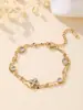 Collar versátil de acero inoxidable de alta gama europeo y americano transfronterizo con colgante de trébol de cuatro hojas incrustado con circonita, pulsera sencilla para mujer