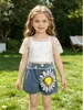 Conjunto de Tres Piezas para Niñas Primavera/Verano 2026 Europeo y Americano Transfronterizo: Blusa Hueca de Color Sólido + Camisola + Jeans con Estampado de Girasol