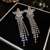 Pendientes Europeos y Americanos Huecos de Estrella de Cinco Puntas Completamente Diamantados Exagerados Lujo Ligero Elegantes con Borla Larga Pendientes Transfronterizos