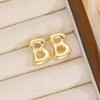 Aretes de burbuja simples con 26 letras de moda europea y americana transfronteriza, nuevos aretes de burbuja de globo lisos dorados para mujer al por mayor