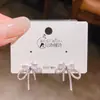 Pendientes de botón de plata con diseño nuevo 2026, con forma de lazo y circonita, para mujer, joyería de moda versátil y exquisita de alta gama
